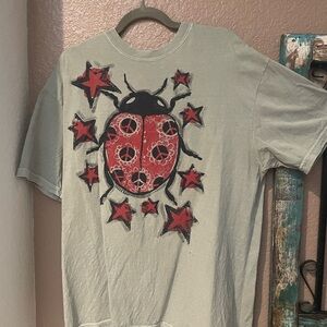 Women’s Graphic Olive Tee with Red Ladybug, peace signs and Stars